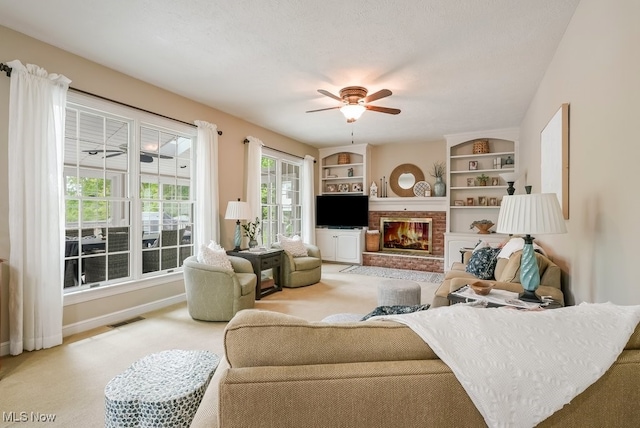 carpeted living room with a brick fireplace, a ceiling fan, and baseboards