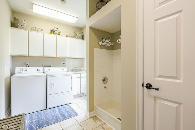 full bathroom with washing machine and dryer, a shower, tile patterned flooring, and a sink
