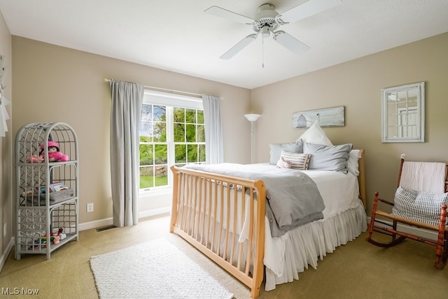 carpeted bedroom with baseboards and ceiling fan