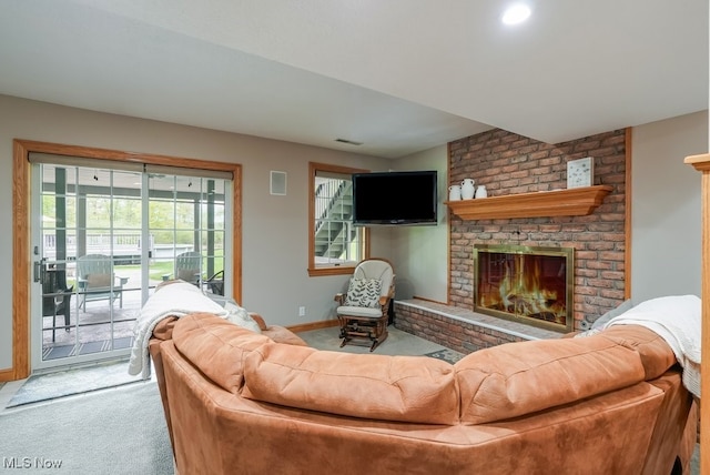 living room with carpet flooring, baseboards, and a fireplace