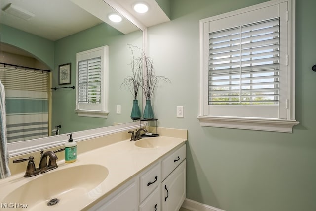 full bath with double vanity and recessed lighting
