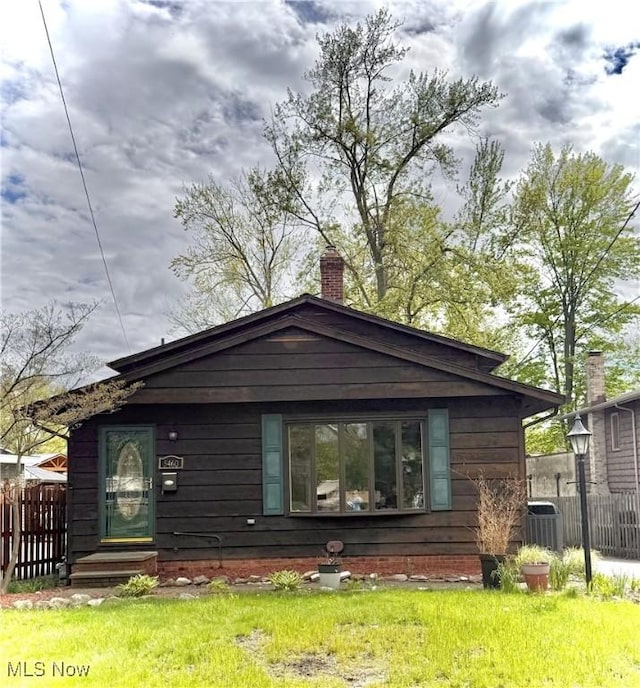 5460 Coronada Dr, Mentor-On-The-Lake, OH 44060 - view of front of house featuring fence, a chimney, and cooling unit