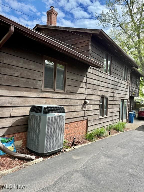 5460 Coronada Dr, Mentor-On-The-Lake, OH 44060 - view of home's exterior featuring cooling unit and a chimney