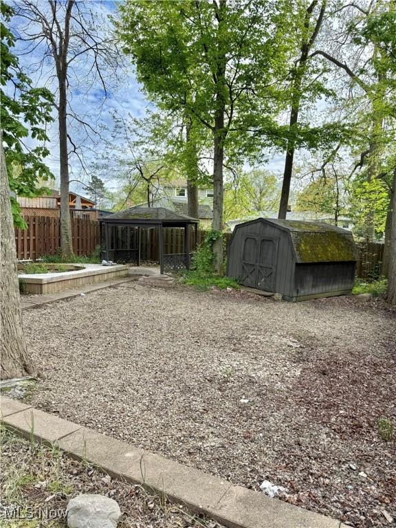 5460 Coronada Dr, Mentor-On-The-Lake, OH 44060 - view of yard featuring a storage shed, fence, and an outdoor structure