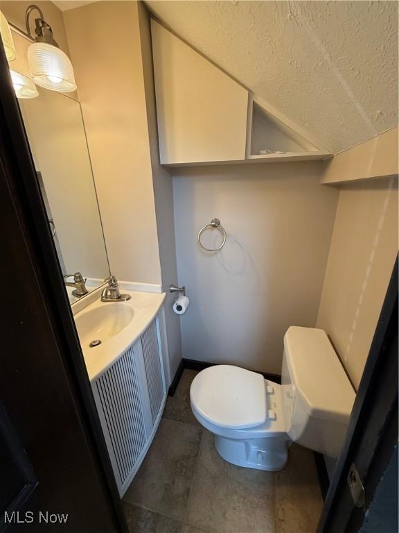 5460 Coronada Dr, Mentor-On-The-Lake, OH 44060 - bathroom featuring toilet, vanity, a textured ceiling, and tile patterned flooring