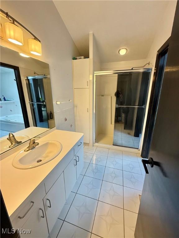 5460 Coronada Dr, Mentor-On-The-Lake, OH 44060 - full bathroom featuring a stall shower, vanity, and marble look tiles