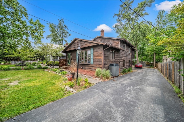 5460 Coronada Dr, Mentor-On-The-Lake, OH 44060 - view of side of home with a chimney, central AC unit, and driveway