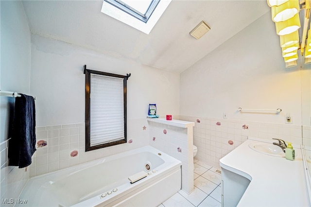 5460 Coronada Dr, Mentor-On-The-Lake, OH 44060 - full bathroom featuring a skylight, lofted ceiling, a garden tub, tile walls, and toilet