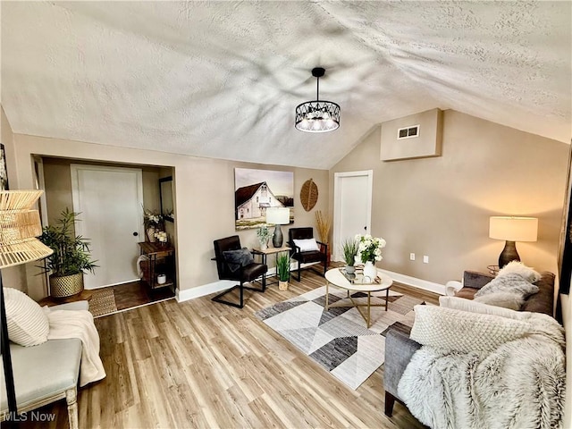 4812 Irma Ave, Youngstown, OH 44514 - living area with a textured ceiling, lofted ceiling, baseboards, a chandelier, and wood finished floors