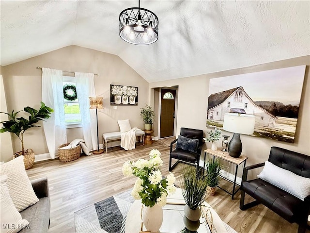 4812 Irma Ave, Youngstown, OH 44514 - living area with wood finished floors, lofted ceiling, and baseboards
