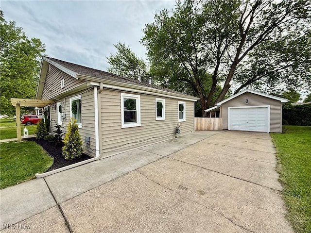 4812 Irma Ave, Youngstown, OH 44514 - view of side of home featuring driveway, an outbuilding, and a garage