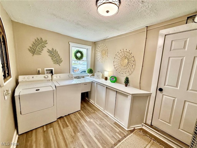 4812 Irma Ave, Youngstown, OH 44514 - laundry area with separate washer and dryer, light wood-style flooring, and a textured ceiling