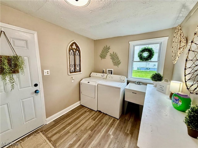 4812 Irma Ave, Youngstown, OH 44514 - laundry room with washer and clothes dryer, light wood-style flooring, a textured ceiling, and baseboards