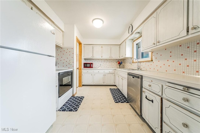 4713 Forest Edge Dr, Brooklyn, OH 44144 - kitchen featuring freestanding refrigerator, dishwasher, a sink, light countertops, and backsplash