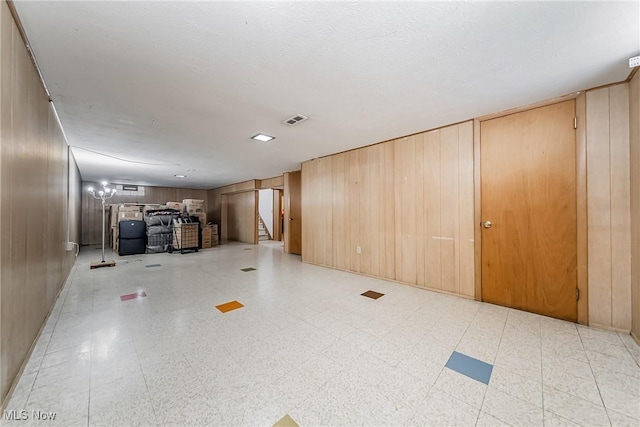 4713 Forest Edge Dr, Brooklyn, OH 44144 - unfurnished living room with stairs and wood walls