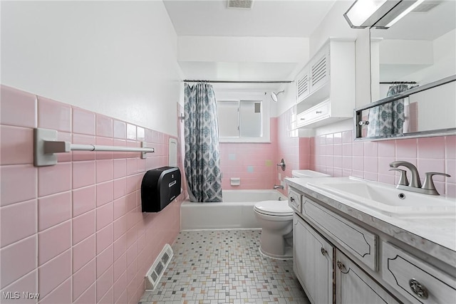 4713 Forest Edge Dr, Brooklyn, OH 44144 - full bathroom with tile walls, vanity, shower / tub combo with curtain, toilet, and wainscoting