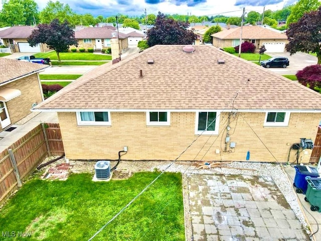 4713 Forest Edge Dr, Brooklyn, OH 44144 - back of house featuring a shingled roof, brick siding, a residential view, a patio, and cooling unit