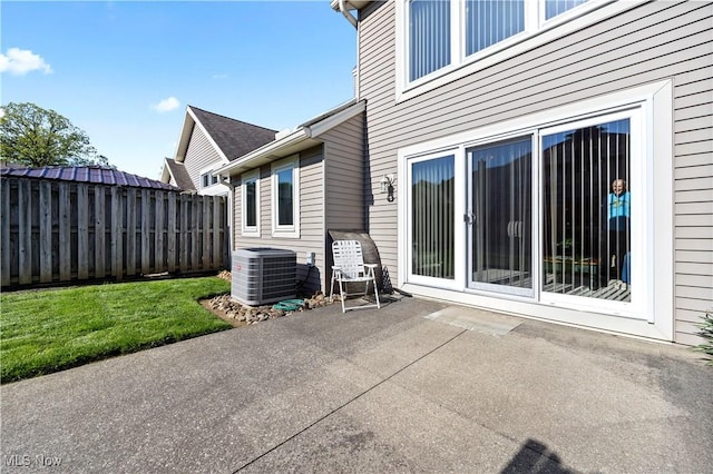 view of patio with fence and central AC