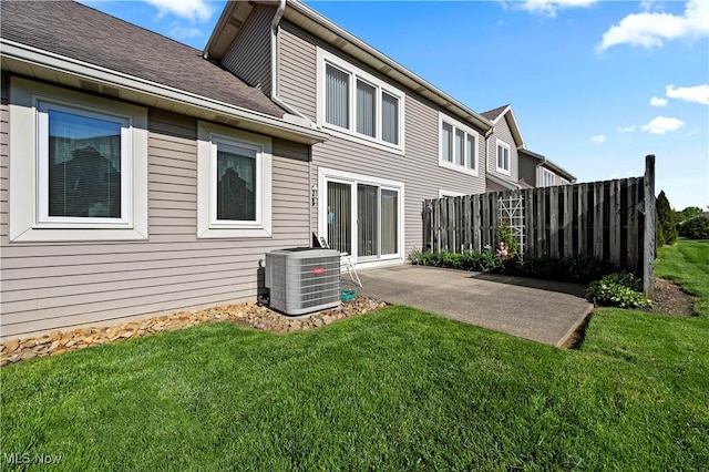 back of property featuring central air condition unit, a patio area, and roof with shingles