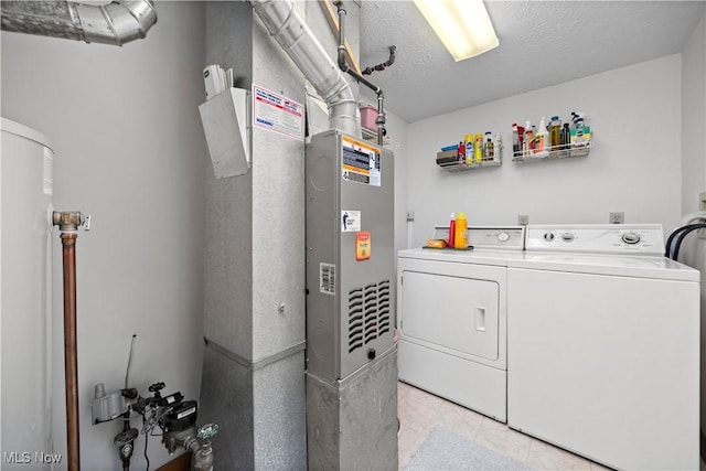 laundry room with washer and dryer, light tile patterned floors, and water heater