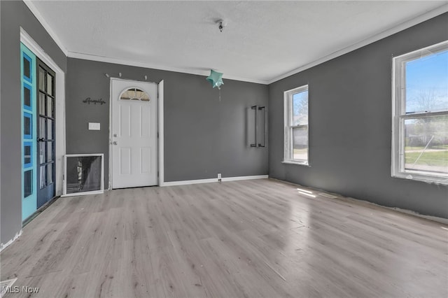 563 Mill St, Conneaut, OH 44030 - spare room with crown molding, wood finished floors, and baseboards