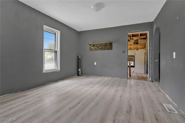 563 Mill St, Conneaut, OH 44030 - unfurnished room featuring arched walkways and light wood-type flooring
