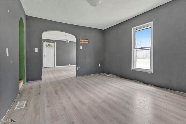 563 Mill St, Conneaut, OH 44030 - unfurnished room featuring arched walkways and wood finished floors