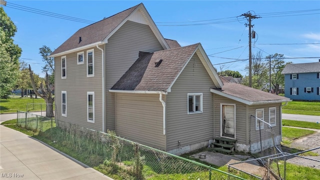 563 Mill St, Conneaut, OH 44030 - view of side of home with entry steps and a shingled roof