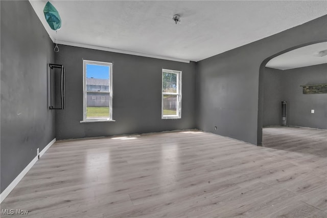 563 Mill St, Conneaut, OH 44030 - unfurnished room with arched walkways and wood finished floors