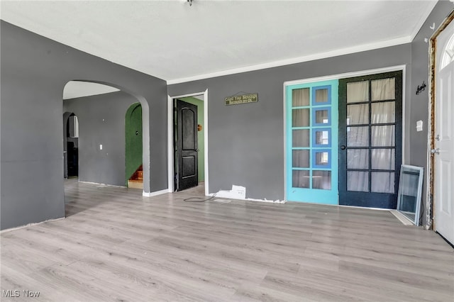 563 Mill St, Conneaut, OH 44030 - empty room featuring wood finished floors and arched walkways