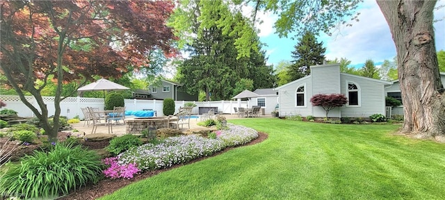 view of yard featuring a patio area, an outdoor fire pit, and outdoor dining space