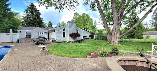 back of house featuring a patio area and a chimney
