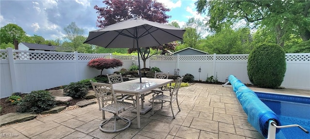 view of patio featuring a fenced backyard and outdoor dining area