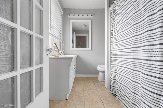 211 Harcourt Dr, Akron, OH 44313 - bathroom with toilet, vanity, and baseboards