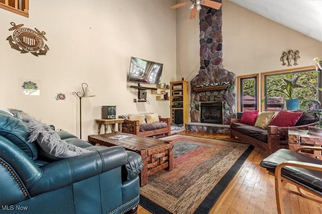 2854 Wells Lock Rd, Elizabeth, WV 26143 - living area featuring hardwood / wood-style flooring, high vaulted ceiling, a stone fireplace, and ceiling fan