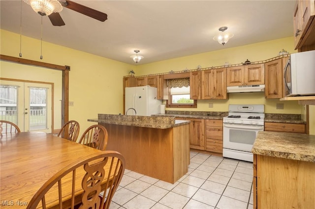 50504 State Route 556, Clarington, OH 43915 - kitchen featuring white appliances, under cabinet range hood, light tile patterned floors, ceiling fan, and a kitchen island