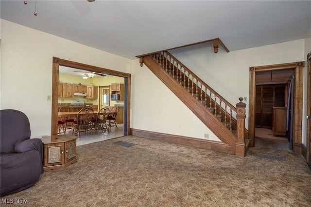 50504 State Route 556, Clarington, OH 43915 - carpeted living room with a ceiling fan and stairway