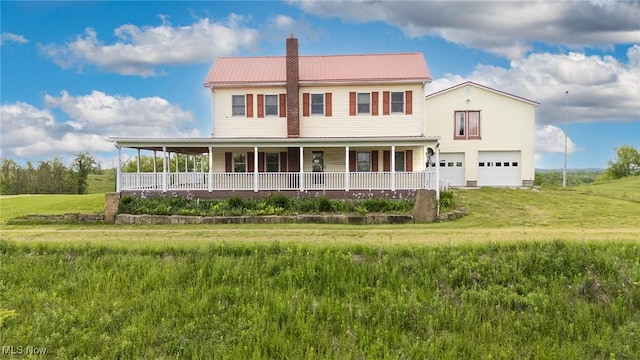 50504 State Route 556, Clarington, OH 43915 - country-style home featuring a chimney, a porch, metal roof, and a front yard