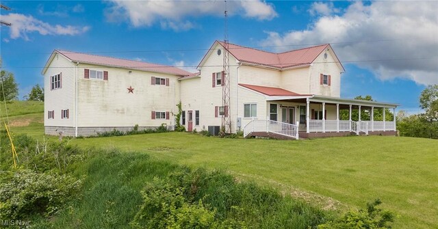 50504 State Route 556, Clarington, OH 43915 - rear view of property featuring central AC, a yard, a porch, and metal roof