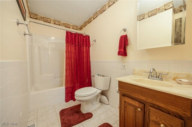 50504 State Route 556, Clarington, OH 43915 - bathroom featuring tile walls, toilet, a wainscoted wall, tile patterned flooring, and vanity