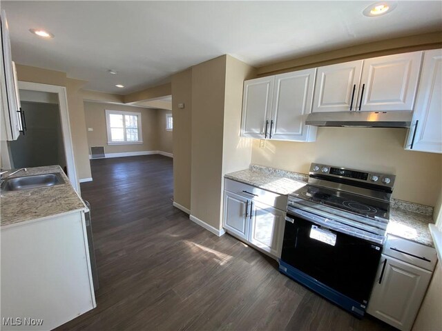 5161 Greenhurst Dr, Maple Heights, OH 44137 - kitchen with stainless steel range with electric stovetop, under cabinet range hood, a sink, white cabinetry, and dark wood finished floors