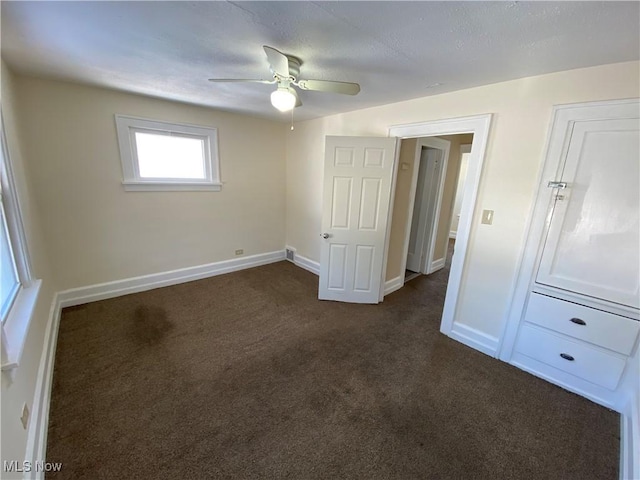 5161 Greenhurst Dr, Maple Heights, OH 44137 - unfurnished bedroom featuring dark carpet, baseboards, and ceiling fan