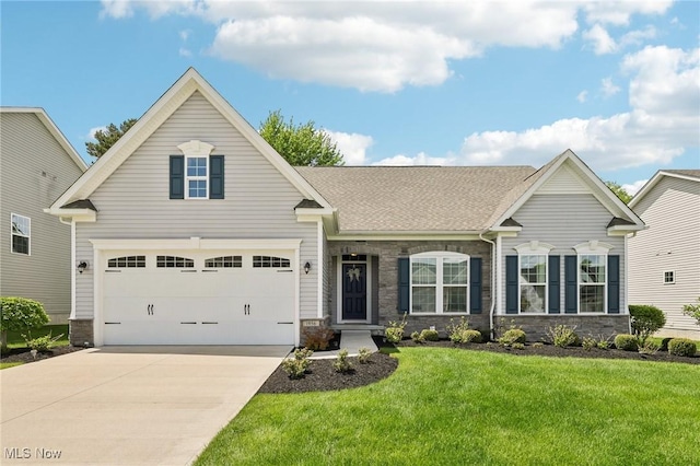 1956 Torrey Park Trl, Painesville, OH 44077 - view of front of home with concrete driveway, stone siding, a front yard, and a shingled roof