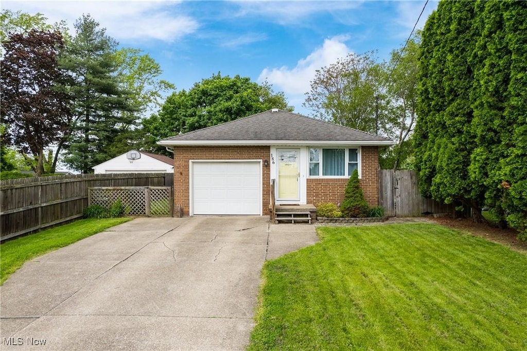 186 Durling Dr, Wadsworth, OH 44281 - view of front of house with brick siding, concrete driveway, a garage, and roof with shingles