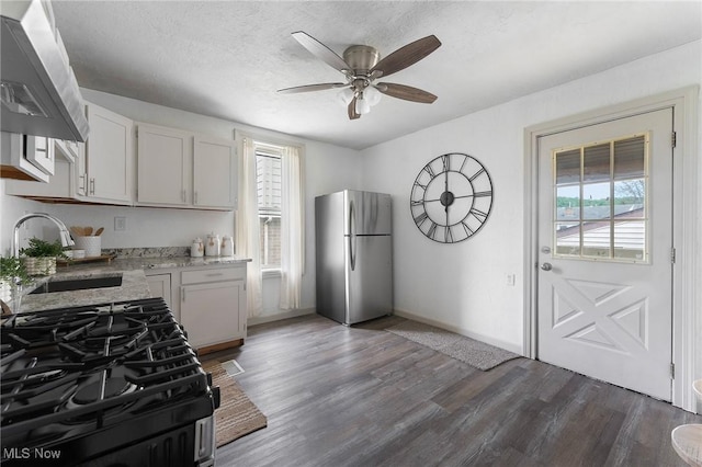 1802 Chester Ave, Wellsville, OH 43968 - kitchen with freestanding refrigerator, a sink, gas range, ceiling fan, and dark wood finished floors