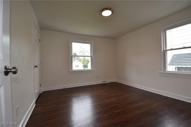 429 N Osborn Ave, Youngstown, OH 44509 - empty room with plenty of natural light, dark wood-style floors, and baseboards