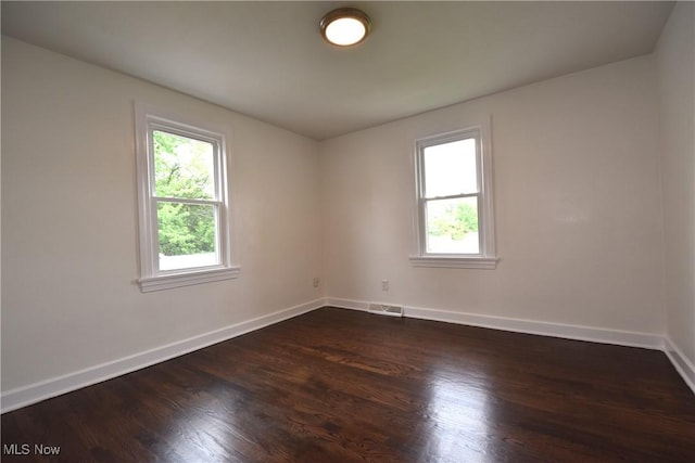 429 N Osborn Ave, Youngstown, OH 44509 - unfurnished room featuring healthy amount of natural light, baseboards, and dark wood-style flooring