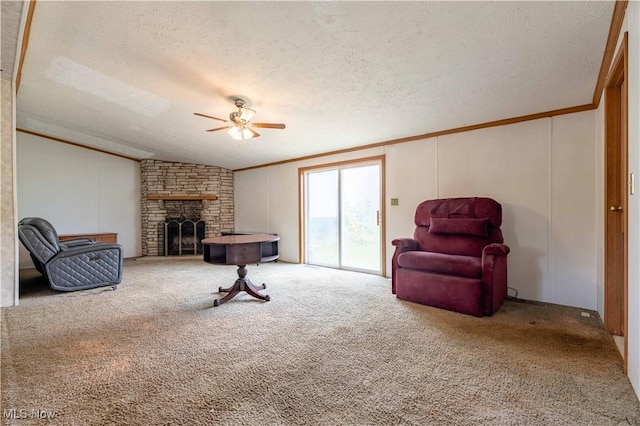 5240 Chalon Rd SW, Carrollton, OH 44615 - sitting room featuring crown molding, ceiling fan, a textured ceiling, a stone fireplace, and carpet flooring