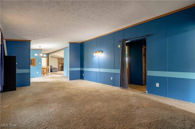 5240 Chalon Rd SW, Carrollton, OH 44615 - empty room featuring a chandelier, carpet, a textured ceiling, and ornamental molding