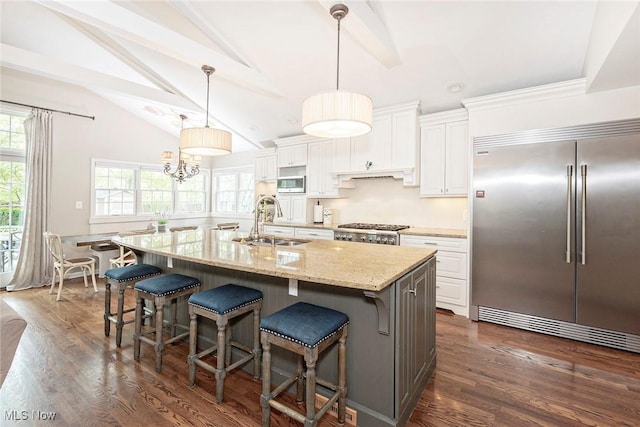 4168 Hadleigh Rd, University Heights, OH 44118 - kitchen with stainless steel appliances, a sink, white cabinets, a large island, and a kitchen breakfast bar